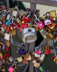 Close-up of padlocks hanging on railing