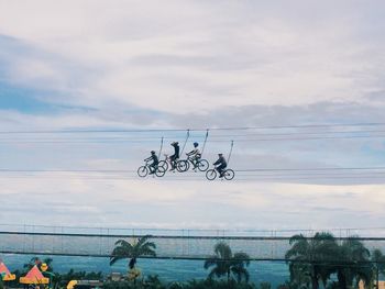 Power lines against cloudy sky