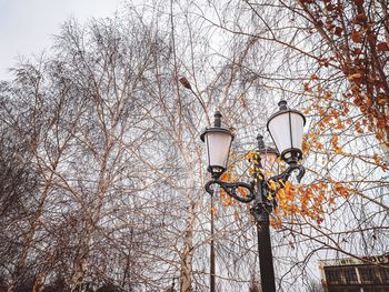 Low angle view of street light against building