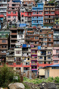 A closeup view of a city on a hill with the houses stacked very closely together .