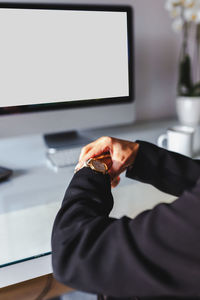 Midsection of man holding camera at home