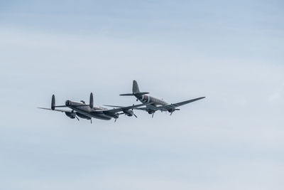 Low angle view of airplane flying against sky
