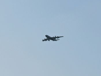 Low angle view of airplane against clear sky