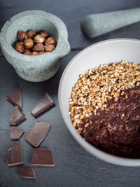 High angle view of chocolate bars and nuts on table