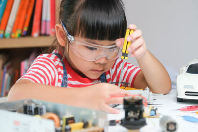 Cute girl playing with toys