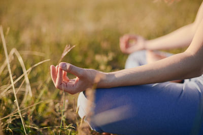 Woman meditating on field