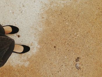 Low section of people standing on tiled floor