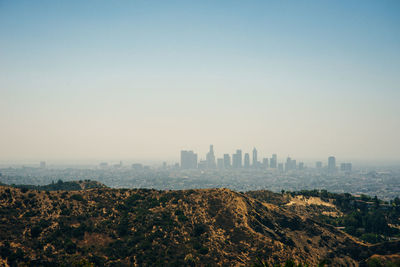 View of buildings in city against clear sky