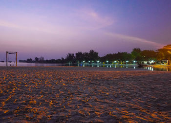 Scenic view of beach against sky at night