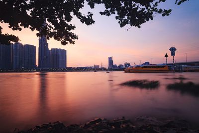 City at waterfront during sunset