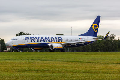 Airplane on field against sky