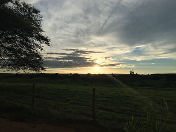 Scenic view of field against sky during sunset