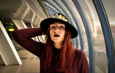 Portrait of fashionable young woman standing on station platform