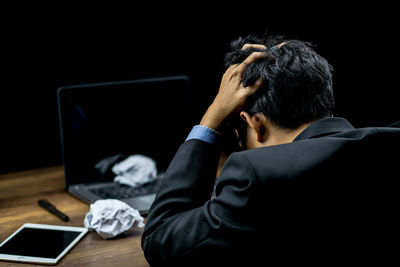 Rear view of man using mobile phone