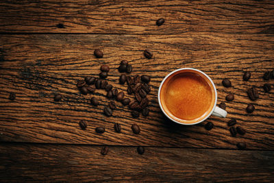 High angle view of coffee cup on wooden table