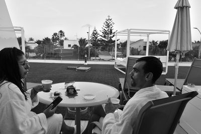 Rear view of men sitting on table in restaurant