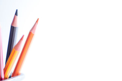 Close-up of pencils against white background