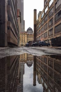 Reflection of buildings in puddle
