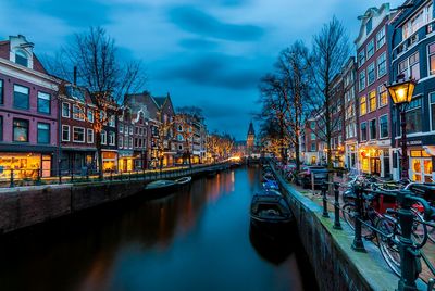 Canal passing through city at night