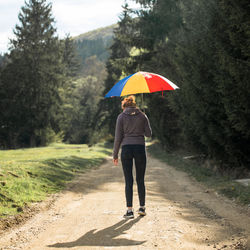 Full length of woman standing on road