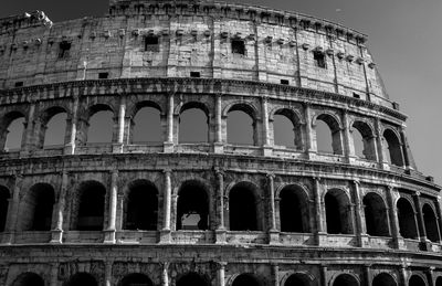 Low angle view of historical building against sky in black and white