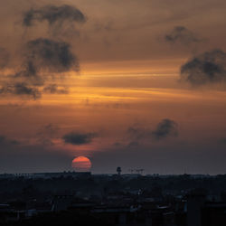 Silhouette buildings against sky during sunset