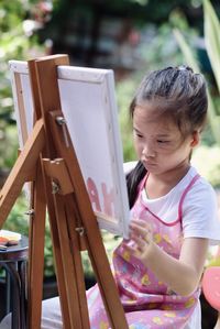 Cute girl painting on canvas 