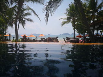 Scenic view of swimming pool by building against sky