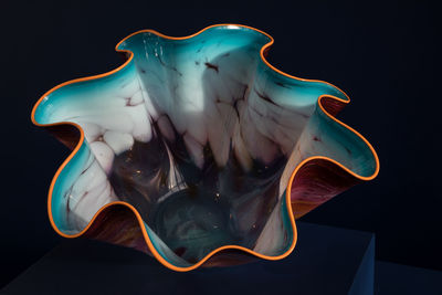 Close-up of painting on table against black background