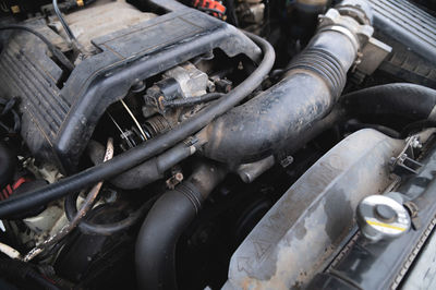 View under the hood of the car. close-up of a v-shaped six-cylinder old engine. dirty engine. time