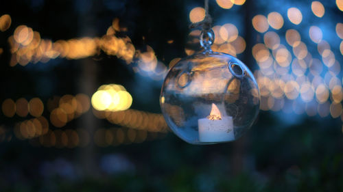 Beautiful evening garden party glass ornaments with candle bokeh of festive light background