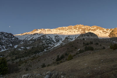 Scenic view of snowcapped mountains against clear sky