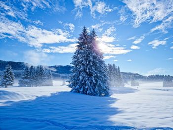 Panoramic view of snow covered landscape against sky