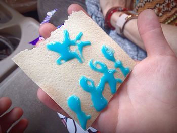 Close-up of hand holding wafer biscuit