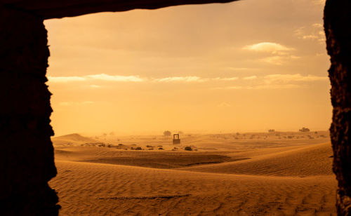 Scenic view of desert against sky during sunset