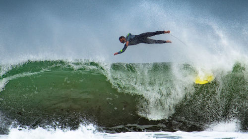 Low angle view of people surfing in sea