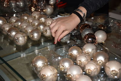 Cropped image of woman arranging christmas baubles