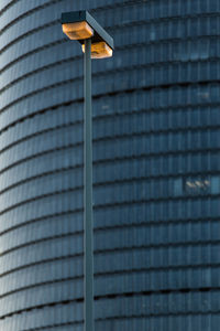 Low angle view of street light against modern building