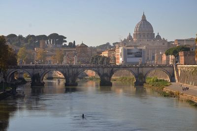 Ponte sant angelo over tiber river against st peter basilica