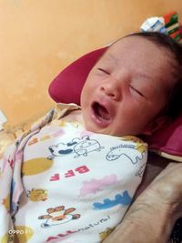 Close-up of cute baby boy at home