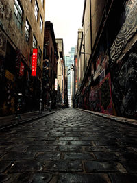 Narrow street amidst buildings in city