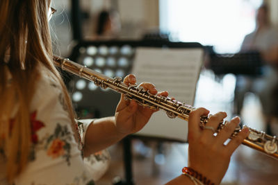 Low angle view of woman playing piano