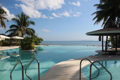 Scenic view of swimming pool by sea against sky