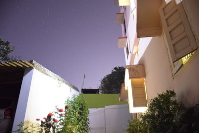 Low angle view of houses against clear sky at night