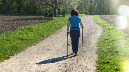 Rear view of man walking on field