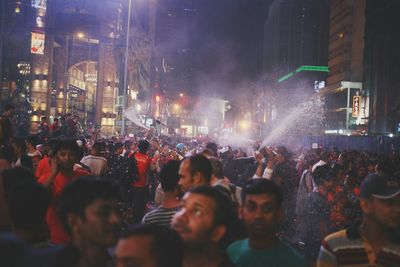 People walking on road along buildings
