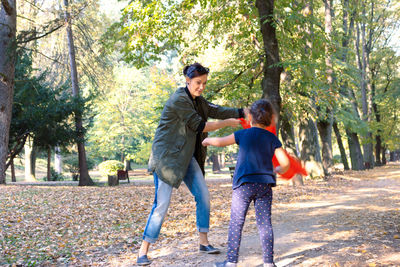 Full length of father and son on tree