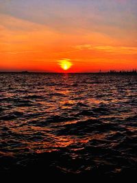 Scenic view of sea against romantic sky at sunset