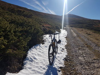 Bicycle on mountain against sky