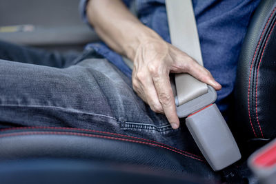 Midsection of man sitting on floor